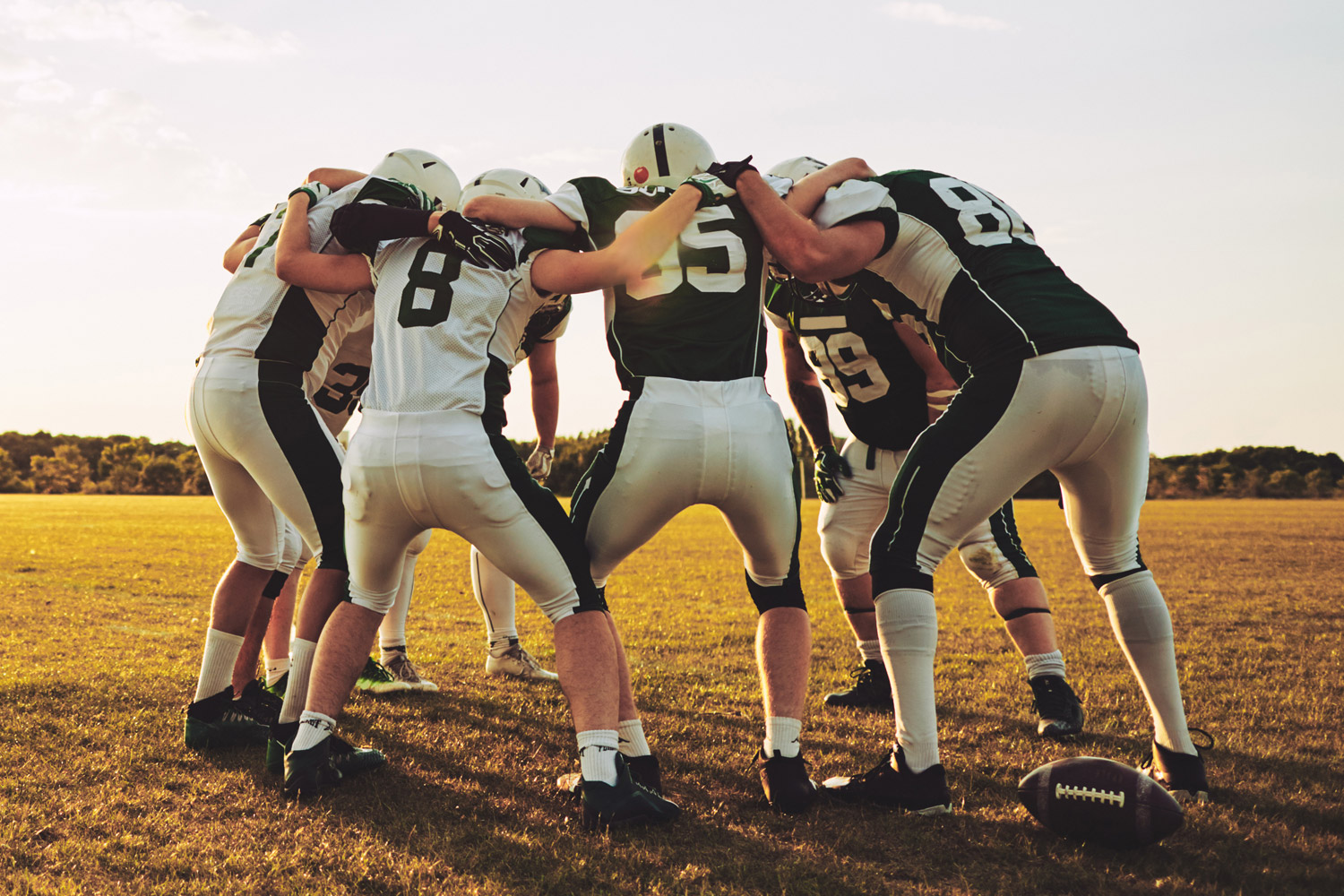 Concussion Clinic photo with football team in a huddle